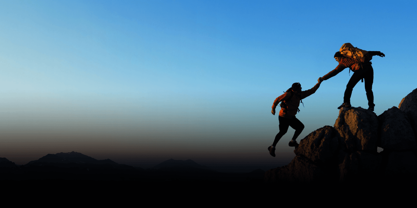 Two person climbing to the top